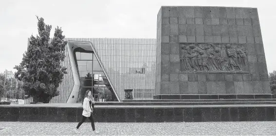  ?? Czarek Sokolowski / Associated Press ?? A woman passes the POLIN Museum of the History of Polish Jews in Warsaw, Poland. Jews in the country have had to deal with a rise in anti-Semitism across Europe while the Polish government has tried to control the historical narrative of the country’s role during the Holocaust.