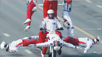  ?? CATHAL MCNAUGHTON / REUTERS ?? The Daredevil motorcycle display team take part in a rehearsal for Thursday’s Republic Day parade in New Delhi, India. A huge crowd gathered to watch the event in the capital, which was being guarded by nearly 50,000 security personnel, according to...