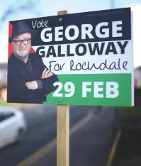  ?? (Phil Noble/Reuters) ?? A PALESTINIA­N FLAG behind candidate George Galloway, leader of the Workers Party of Britain, adorns a bill board in Rochdale.