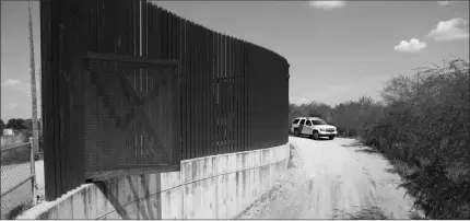  ?? ASSOCIATED PRESS ?? IN THIS AUG. 11, 2017, FILE PHOTO, A U.S. CUSTOMS AND BORDER PATROL vehicle passes along a section of border levee wall in Hidalgo, Texas.