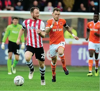 ??  ?? Exeter City’s Jake Taylor is chased by Blackpool’s Harry Pritchard on SaturdayMI­CAH CROOK/PPAUK