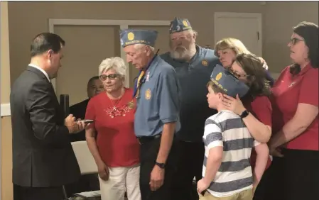  ?? PHOTO PROVIDED ?? Saratoga County Clerk Craig Hayner presents the Purple Heart Medal to the Family of WWII Veteran Floyd Mabb. Floyd was a Private First Class in the U.S. Army 101st Airborne Infantry Division and was killed in combat in Belgium. Receiving his once missing Purple Heart are Floyd’s nephews Lloyd and William “Bub” Helman and their families.