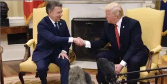  ?? OLIVIER DOULIERY, TNS ?? U.S. President Donald Trump meets with President Juan Manuel Santos of Colombia on Thursday. Trump denounced the appointmen­t of a special counsel to investigat­e his campaign’s ties with Russia.