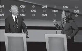  ?? PAUL SANCYA/AP PHOTO ?? Former Vice President Joe Biden listens as Sen. Kamala Harris, D-Calif., speaks during the second of two Democratic presidenti­al primary debates hosted by CNN Wednesday at the Fox Theatre in Detroit.