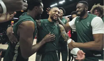  ?? GETTY IMAGES ?? Damian Lillard of the Milwaukee Bucks is cheered on by teammates.