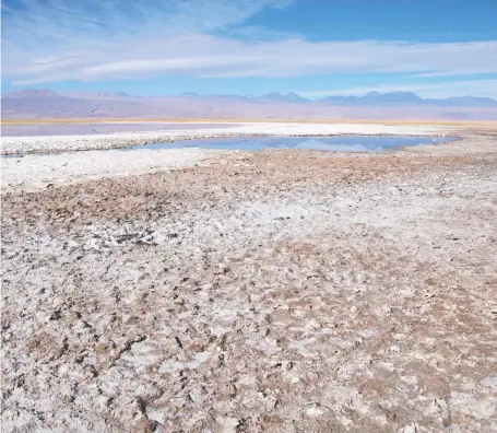  ?? LAURa MILLAN LOMBRaNA/BLOOMBERG ?? A lagoon sits in the middle of the Atacama salt flat in Chile. The huge increase in lithium demand is drawing more mining companies into the Atacama and other salt flats in the Andes, but experts warn there’s a risk that the salt flats will run out of water.