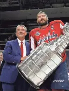  ?? ALEX BRANDON/AP ?? Capitals owner Ted Leonsis, left, and winger Alex Ovechkin of Russia are all smiles while holding the Stanley Cup.