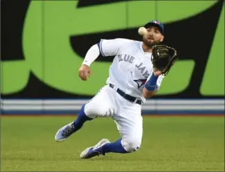  ?? DAN HAMILTON, USA TODAY SPORTS ?? Blue Jays centre-fielder Kevin Pillar makes a sliding catch at Rogers Centre Friday night. The Blue Jays lost 2-1.