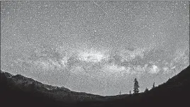  ?? [NILS RIBI PHOTOGRAPH­Y VIA THE ASSOCIATED PRESS] ?? The Milky Way can be seen in the night sky at the foot of the Boulder Mountains in the Sawtooth National Recreation Area of Idaho. The area could be designated the nation’s first Internatio­nal Dark Sky Reserve if officials and residents there get their...