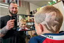  ?? PHOTO: BRADEN FASTIER/FAIRFAX NZ ?? Tasman Makos fan Nixon Marfell, 7, has a shark shaved on the side of his head by Nathan Nuku Nuku to show support for the team.