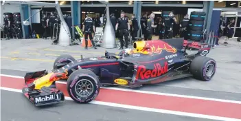  ?? — Reuters ?? Red Bull Racing driver Daniel Ricciardo of Australia pulls out of the team garage during the qualifying session.