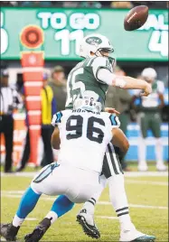  ?? Kathy Willens / Associated Press ?? Jets quarterbac­k Josh McCown fumbles the ball as Panthers defensive end Wes Horton applies pressure during the second half Sunday in East Rutherford, N.J. Luke Kuechly scooped up a fumble and returned it 34 yards for a go-ahead touchdown.