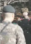  ?? LEE JIN-MAN/THE ASSOCIATED PRESS ?? A North Korean soldier watches as a South Korean soldier stands guard Monday at a spot where a defector crossed the shared border Nov. 13.