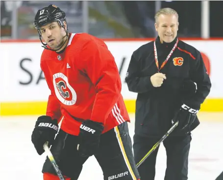  ?? GAVIN YOUNG/FILES ?? Flames forward Milan Lucic and head coach Geoff Ward, seen here in February, say they are excited to hit the ice again and get ready for an unusual jump into the playoff season as the NHL season ramps up with training camps.