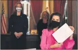  ?? EXECUTIVE OFFICE OF THE MICHIGAN
GOVERNOR ?? Michigan Gov. Gretchen Whitmer is pictured after signing Senate
Bill 757into law on Tuesday, joined by Michigan Secretary of State Jocelyn Benson, rear left.