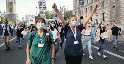  ?? | ?? OVERLOOKED
BRITISH National Health workers march in protest to Downing Street in London, yesterday, saying they have been overlooked by the government in the latest round of public sector pay rises – despite them being on the frontlines of the Covid-19 crisis for the past five months. More than 500 NHS and care workers have died after exposure to Covid-19, amid an alleged failure to provide them with suitable PPE.