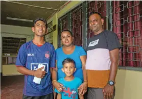  ?? Photo: Leon Lord ?? From left: Prashant Frances 17, Ashika Mala (mother) Prem Kishan (father) and Aaron Kishan 6, after picking their education assistance forms at Nabua Secondary School on January 11, 2023.