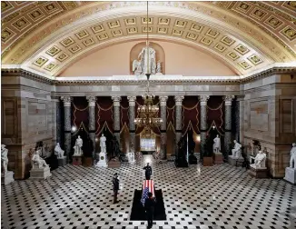 ?? CHIP SOMODEVILL­A / POOL VIA AP ?? The flag-draped casket of Justice Ruth Bader Ginsburg is saluted before being carried out of Statuary Hall in the U.S. Capitol after Ginsburg lay in state Friday.