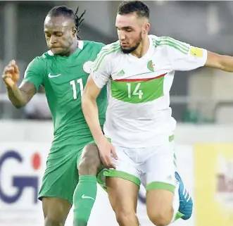  ??  ?? Victor Moses of Nigeria and Nabil Bentaleb of Algeria on fight for control of the ball during the 2018 FIFA World Cup match in Uyo on November 12, 2016