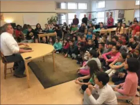  ?? MICHAEL GWIZDALA— DIGITAL FIRST MEDIA ?? Students gather around to listen to John Gray at Woodland Hill Montessori School.