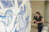  ?? ROBERTO BARRIOS ?? Chilcote, a graduate of McCormick Theologica­l Seminary, paints a portion of the mural at the Hyde Park school in 2021.