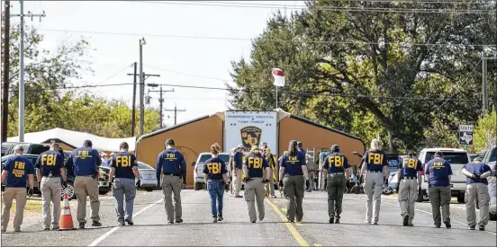  ?? statesman.com.. JAY JANNER / AMERICAN-STATESMAN ?? FBI agents conduct a search for evidence Monday on FM 539 at First Baptist Church in Sutherland Springs, where a gunman killed 26 people Sunday. Keep up with the latest developmen­ts and see videos and photos on