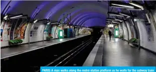  ?? — AFP ?? PARIS: A man walks along the metro station platform as he waits for the subway train on April 1, 2020.