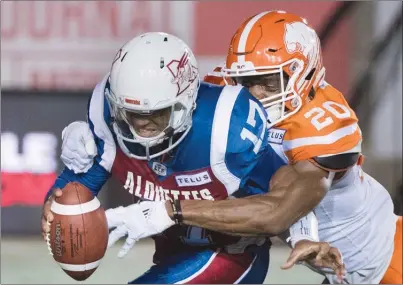  ?? The Canadian Press ?? Bo Lokombo of the B.C. Lions, right, sacks Montreal Alouettes quarterbac­k Antonio Pipkin during first-half CFL action in Montreal on Friday evening.The Lions won 32-14.