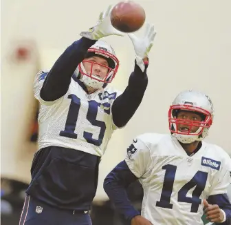  ?? STaFF PhOTO by maTT WesT ?? IN THE GRASP: Chris Hogan makes a catch in front of fellow receiver Brandin Cooks during yesterday’s practice in Foxboro.