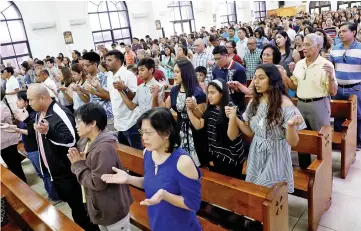  ??  ?? Residents pray during a Sunday mass at Sta Barbara Church on the island of Guam. — Reuters photo