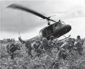  ??  ?? WAR LEGACY. A 1970 photograph showing US soldiers descending from a helicopter after a sweep east of the Cambodian town of PreyVeng during the Vietnam War.