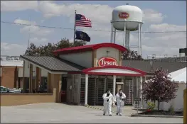  ?? MICHAEL CONROY — THE ASSOCIATED PRESS FILE ?? Workers leave the Tyson Foods pork processing plant in Logansport, Ind.