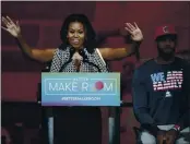  ?? TONY DEJAK — THE ASSOCIATED PRESS FILE ?? On Oct. 21, 2015, former first lAdy Michelle OBAmA speAks At the University of Akron As NBA stAr LeBron JAmes listens Behind her in Akron, Ohio.