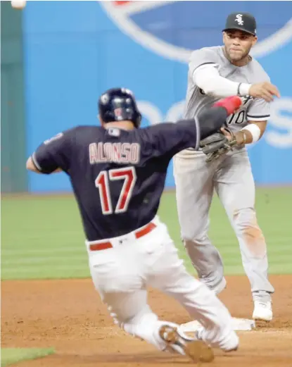  ?? AP ?? Yoan Moncada, who went 3-for-5, throws to first after forcing out the Indians’ Yonder Alonso on a double play in the third inning.