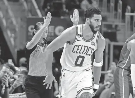  ?? AP ?? Celtics forward Jayson Tatum reacts after making a 3-pointer against the Pistons on Monday in Detroit. The Celtics have won three of their last four games.