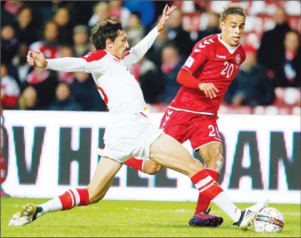  ?? (AP) ?? Montenegro’s Stefan Savic (left), and Denmark’s Yussuf Poulsen battle for the ball during the World Cup group E qualifying soccer match between Denmark and Montenegro at the Parken Stadium in Copenhagen on Oct 11.