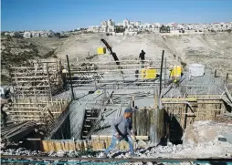  ?? (Ammar Awad/Reuters) ?? LABORERS WORK at a constructi­on site in Ma’aleh Adumim.