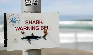 ?? GEORGE HEARD/STUFF ?? The St Clair shark bell sounded every few weeks following a string of shark deaths. Swimmers, divers and surfers would leave the water for 15 minutes before re-entering.