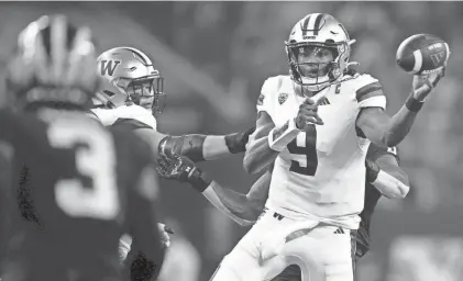  ?? ?? Washington quarterbac­k Michael Penix Jr. passes against Michigan in the College Football Playoff championsh­ip game Monday night in Houston.