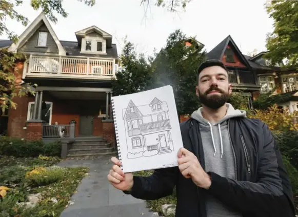  ?? BERNARD WEIL/TORONTO STAR ?? Artist Jake Tobin Garrett with his drawing of the house behind him, 533 Palmerston Blvd.