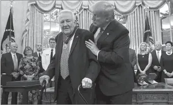  ?? -AP ?? President Donald Trump awards the Presidenti­al Medal of Freedom to former Attorney General Edwin Meese in the Oval Office of the White House.