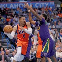  ?? AP ?? Thunder guard Russell Westbrook (left) passes the ball around Pelicans forward Solomon Hill during their NBA game. —