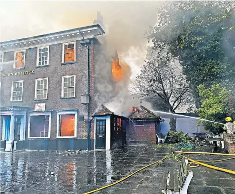  ?? ?? Twelve fire engines tackled the blaze that destroyed the roof and damaged three floors of the Burn Bullock pub, which had been empty for more than 10 years
