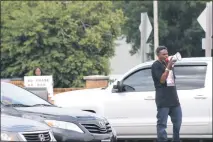  ??  ?? Aubrey Robinson of Accokeek protests against high-speed police chases and runs at the intersecti­on of Route 231 and Route 4 in Prince Frederick. Robinson’s son, Tabias, died during a police chase in April. His sister, Aleta Chase of St. Leonard, stands...