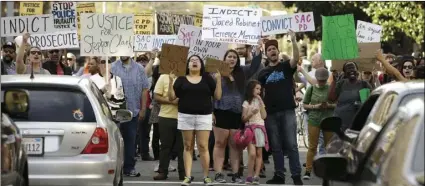  ?? AP PHOTO/RICH PEDRONCELL­I ?? In this March 29 file photo, protestors block an intersecti­on in downtown Sacramento after the funeral for police shooting victim Stephon Clark. Sacramento Police Chief Daniel Hahn, the city’s first black police chief, is an unlikely officer, growing...