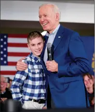  ?? (File Photo/AP/Andrew Harnik) ?? Then-Democratic presidenti­al candidate former Vice President Joe Biden hugs Brayden Harrington on Feb. 10, 2020, at a campaign stop in Gilford, N.H. Brayden spoke with Biden about having a stutter. “I want to carry on what Joe Biden said to me,” Harrington said later. “That this does not define you and that you can be much more than you see yourself as.”