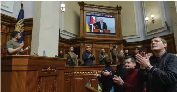  ?? Reuters ?? British Prime Minister Boris Johnson receives a standing ovation from Ukrainian MPs and President Volodymyr Zelenskyy during an address to the parliament in Kyiv