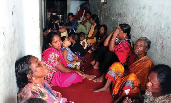  ?? Getty ?? Family members of missing fishermen wait for news in Thiruvanan­thapuram, Kerala, India