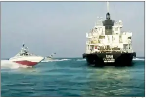  ?? AP/Press TV ?? An undated photo from Iranian state television’s English-language service, Press TV, shows Iranian Revolution­ary Guard vessels circling a Panamanian-flagged oil tanker that was intercepte­d Sunday in Iranian waters in the Strait of Hormuz, reportedly for smuggling oil.