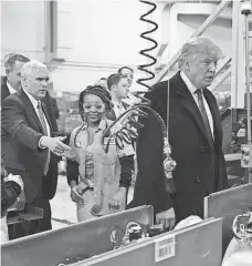  ?? TIMOTHY A. CLARY, AFP/GETTY IMAGES ?? President-elect Donald Trump and Vice President-elect Mike Pence visit the Carrier company in Indianapol­is on Thursday.